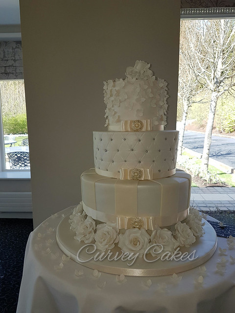White and Ivory Pearled Wedding Cake with Roses around the Bottom by Jean & Selina in Curvey Cakes