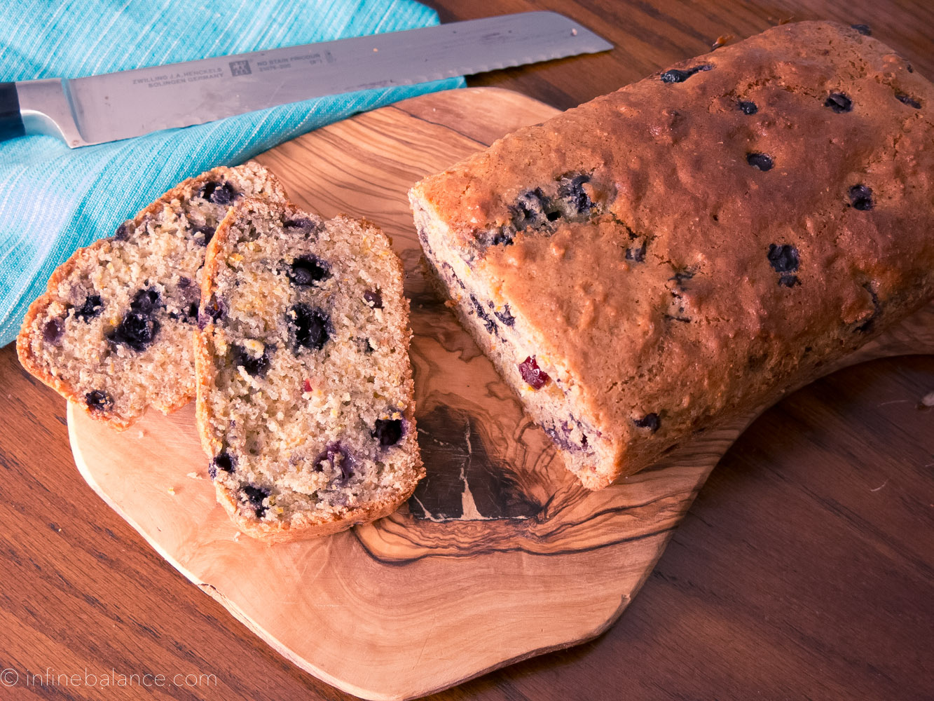 blueberry citrus loaf sliced on a cutting board