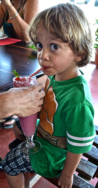kid drinking a fresh smoothie in la danta restaurant in flores guatemala