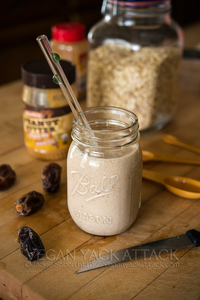 Beige-tan smoothie in a jar on a wood countertop
