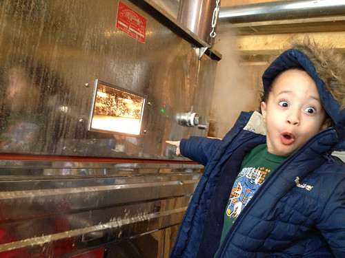 A youngster enjoying how maple syrup is made. NRCS photograph.