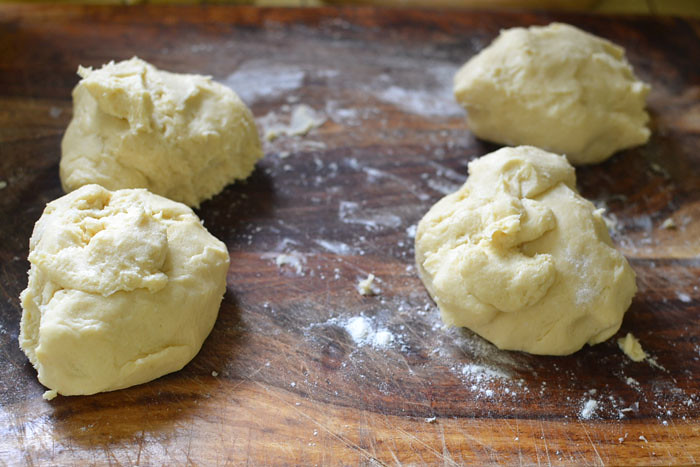 Add flour and mix until just combined. Dump the dough onto a well floured surface and roll into a ball. Cut the ball in quarters and wrap each quarter in plastic wrap. Refrigerate for at least 20 minutes or in the freezer for 15 minutes.