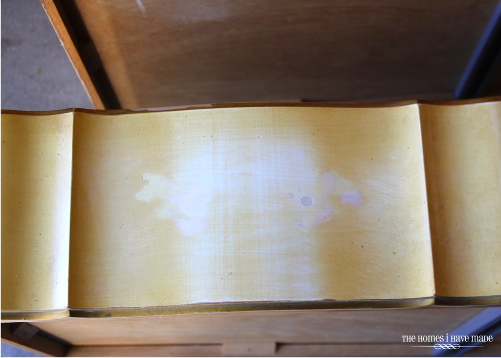 Woodfiller fills in holes on a dresser drawer