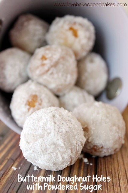 Buttermilk Doughnut Holes with Powdered Sugar piled up.