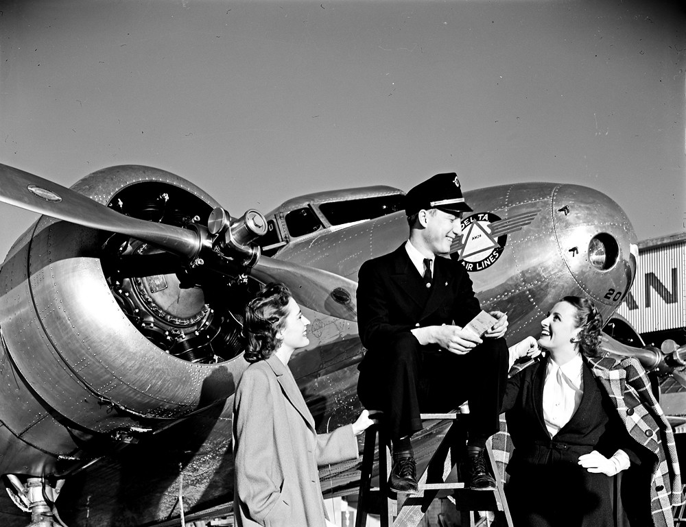 [Station Agent and Two Models in front of Lockheed 10B Electra, Delta Air Lines]