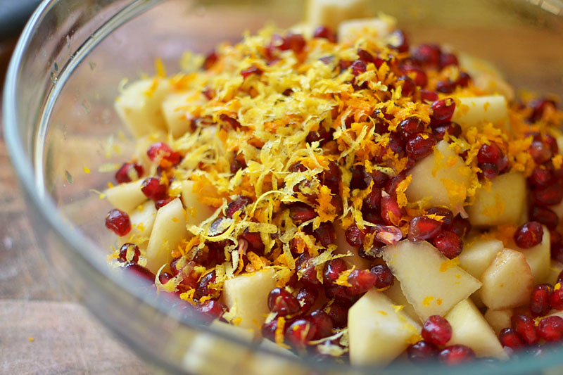 Filling for pear crumble with lots of orange zest, pomegranate seeds, cubed pears and spices.