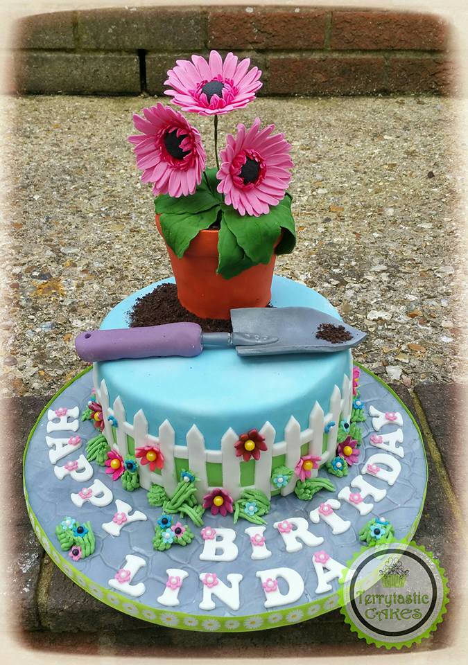 Gardening Themed Cake with a Pot of Wired Sugar Gerbera's and a Trowel by Terrytastic Cakes