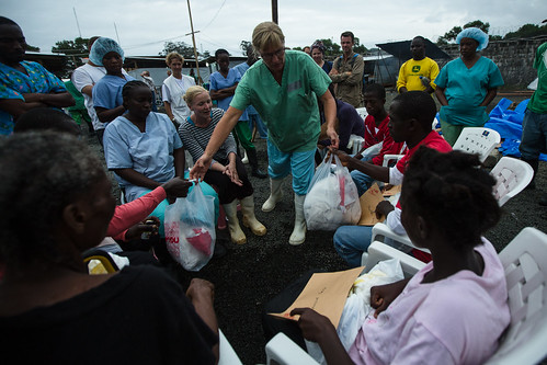 Doctors Without Borders staff distribute take-home kits for Ebola survivors in Liberia