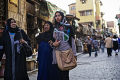 Egyptian girl and women walking in Khan el-Khalili Bazaar, Cairo, Egypt