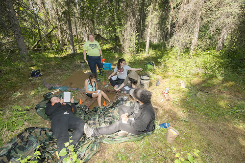 Participants in one of the tribe's Susten archaeology camps work in June on journal entries after laboring on a dig in the Kenai National Wildlife Refuge near Swan Lake Road.