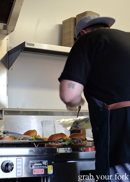 Prepping burgers on the Mister Gee Burger Truck at Burwood Deluxe Car Wash