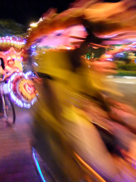 Decorated Rickshaw on the Move in Melaka, Malaysia