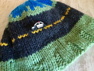 Nothing ever happens on my block hand knit child's hat with fire truck and police car buttons