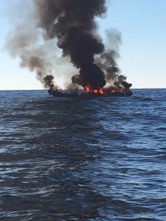 The Coast Guard and a good Samaritan rescued four people whose boat caught fire off the coast of Murrells Inlet, south of Myrtle Beach, Dec. 14, 2014. One of the four was medevaced after displaying symptoms of hypothermia.