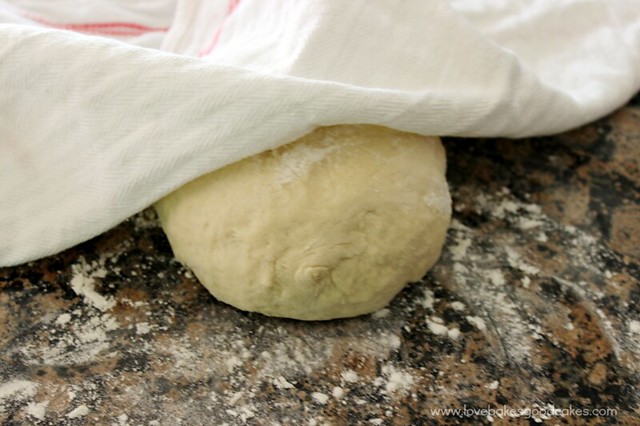 Dough being covered to rise on a counter top.
