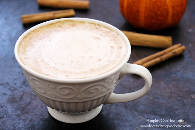 Pumpkin Chai Tea Latte in a cup with cinnamon sticks.