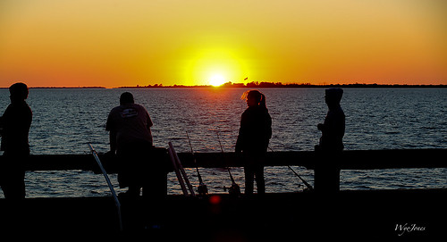 sunset sun water stpetersburg bay fishing waves fishermen wind tampabay florida flag poles sunshineskyway mulletkey wyojones skywaystatefishingpiers