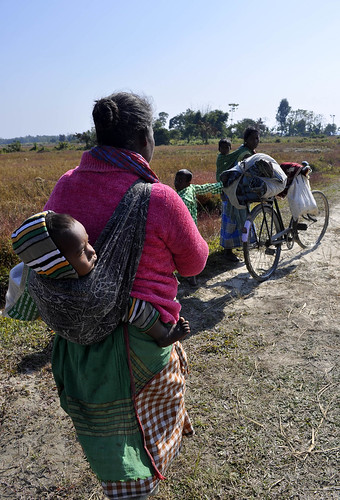 A family of Adivasi returns back to their home on Wednesday from a relief camp in Kokrajhar district