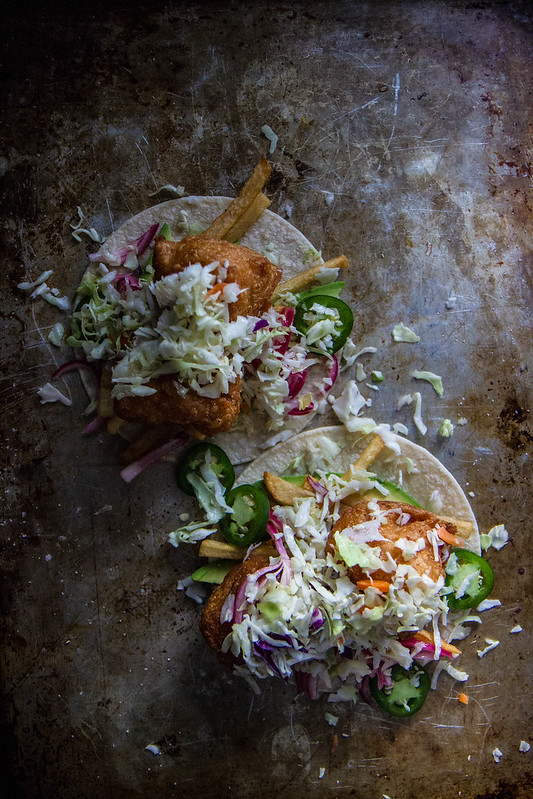 Kitchen Sink Tacos with avocado, jalapeño, pickled onions, french fries, fried shrimp and slaw!