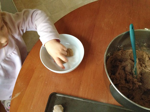 rolling gingersnaps in sugar