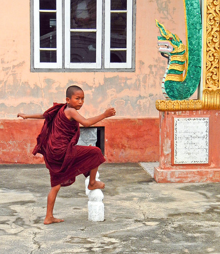 A Child Monk Playing at the Monastery near the Entrance to Inle Lake, Myanmar