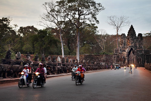 road sunset people orange blur canon temple gate cambodia bokeh buddha ruin motorcycles carving depthoffield angkor buddhas angkorthom t3i 600d gsamie guillaumesamie