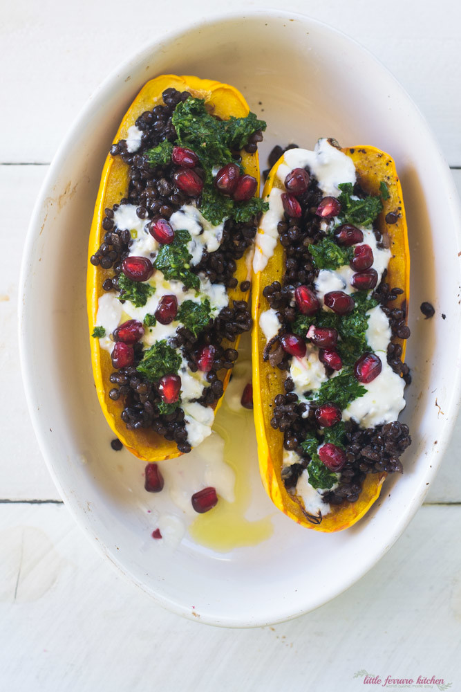 Stuffed delicata squash is flavored with bold Mediterranean flavors of cumin lentils, creamy yogurt feta sauce and sweet pomegranate seeds.