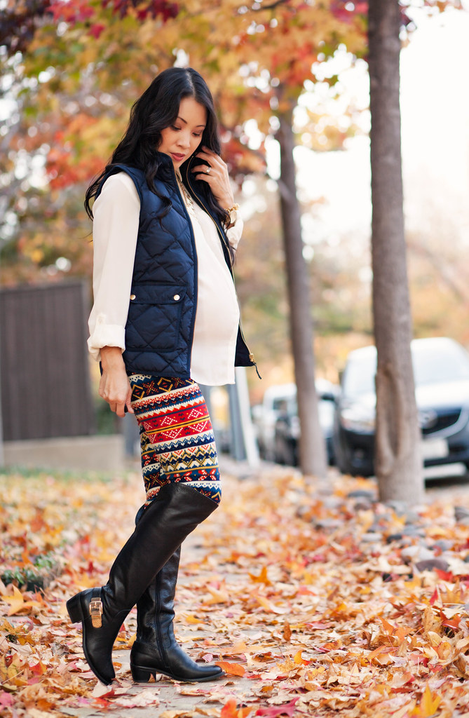 cute & little blog | petite fashion #maternity #bumpstyle #thirdtrimester | white blouse, navy quilted puffer vest, white plum tribal print leggings, otk boots | fall winter outfit