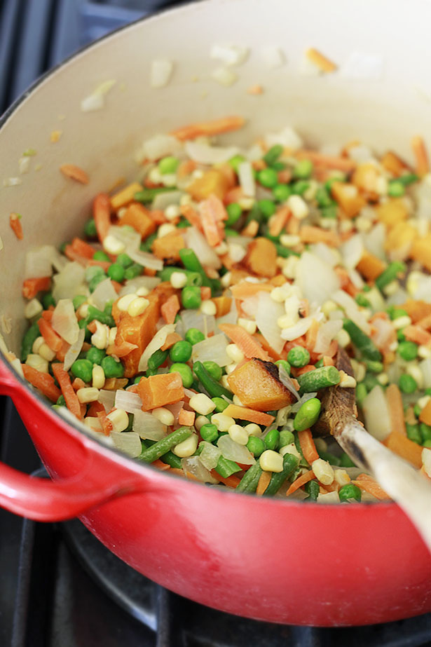 Vegetables get sauteed in a Dutch oven for pot pie filling. 