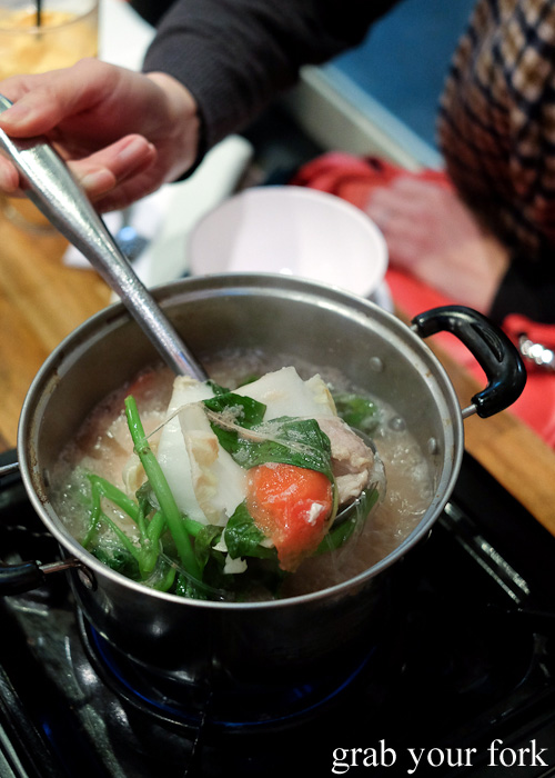 Cooking the pork and liver in the spicy herb soup at E-San Saap Thai, Sydney