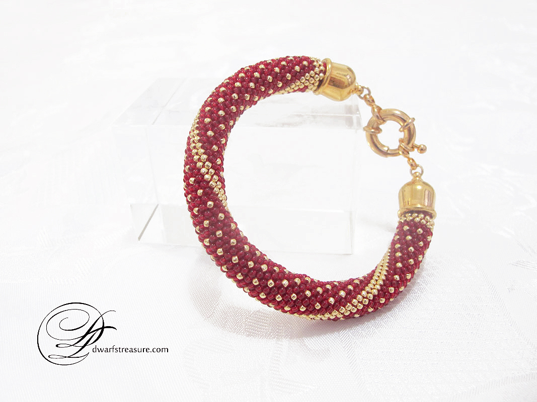 Ornate bright red beaded crochet bangle with gold pattern