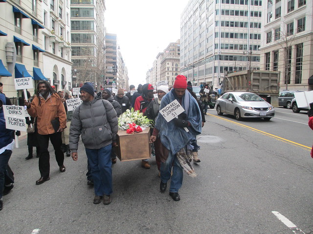 Advocates carry an empty caskets through the streets of DC to memorialize those who dies without a home throughout 2014 in the District. | Photo by Ken Martin