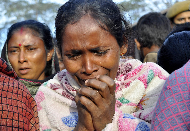 An Adivasi woman breaks down in a relief camp in Kokrajhar district