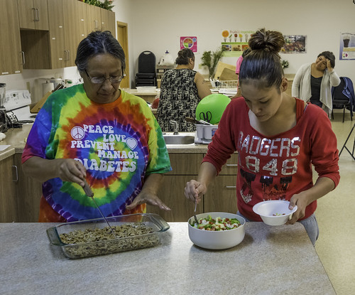 Participants in the Menominee Indian Tribe of Wisconsin’s monthly cooking class sample the new recipes they learned to prepare, cereal treats with wheat bran flakes and zippy zucchini salad. USDA Photo by Bob Nichols.