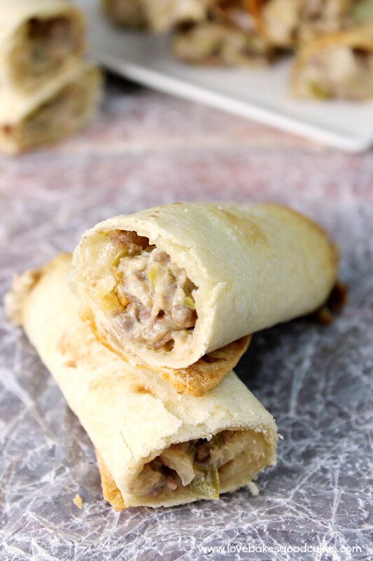 Philly Cheesesteak Taquitos on parchment paper.
