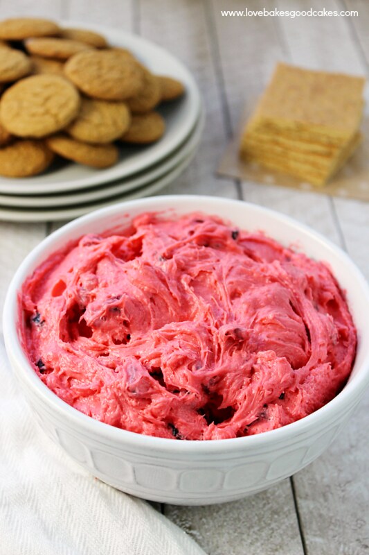Cranberry Cream Cheese Dessert Spread in a white bowl with crackers on a plate.