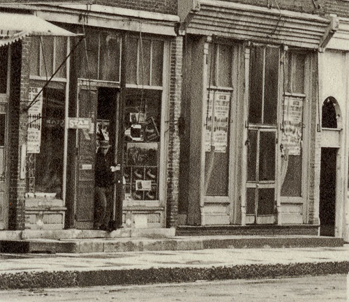 horses people usa signs man men history buildings advertising awning hardware cafe general garage restaurants indiana streetscene drugs shops pedestrians storefronts theaters grocery monticello businesses wagons theatres whitecounty realphoto hoosierrecollections