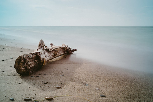 longexposure beach log sand waves michigan dunes lakemichigan driftwood puremichigan