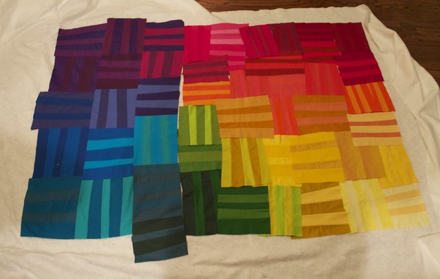Photo shows a rainbow improv quilt in progress by Bryan House Quilts