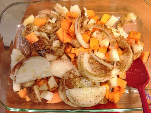 seasoning the veggies for roasted potatoes and butternut squash
