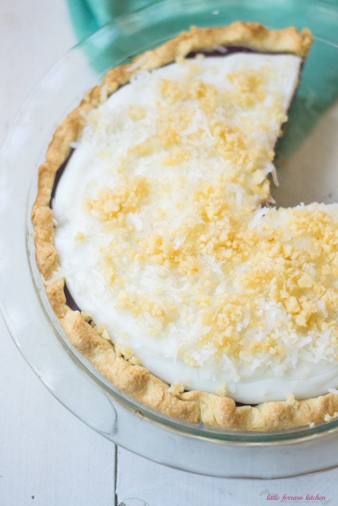 Purple sweet potato haupia pie with deep purple potatoes and a coconut layer topped with macadamia nuts and shredded coconut.