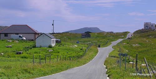 barra scotland westernisles outerhebrides scenic road countryroad windingroad fields fences houses landscape outdoor buildings hill view
