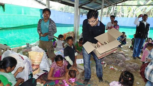 Members of MyFacts distributing relief materials in camps, Children react to camera in a relief camp