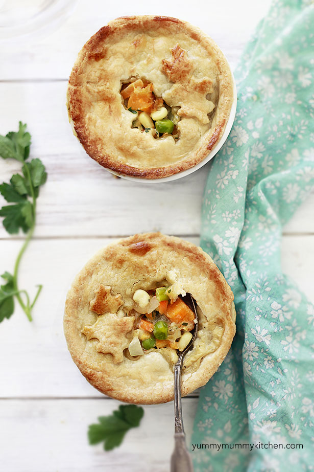 Individual vegetable pot pies filled with peas, carrots, corn, edamame, and roasted butternut squash for a hearty family friendly vegetarian dinner. 