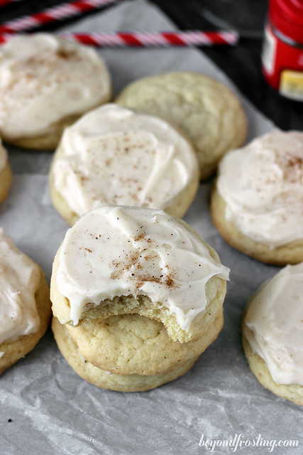 Stacks of eggnog sugar cookies with a bite taken out of one.
