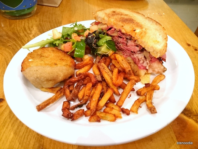 Smoked meat sandwich with salad and fries