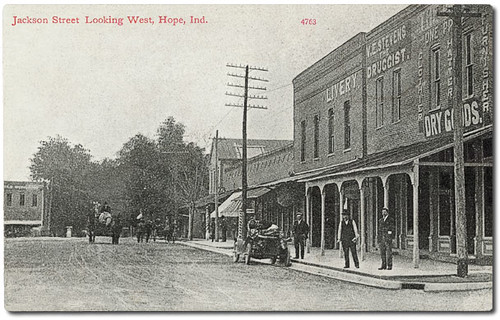 horses people usa signs man men history cars buildings advertising awning hope hardware clothing hats indiana streetscene transportation drugs pedestrians storefronts grocery buggy buggies automobiles businesses wagons barbers livery bartholomewcounty hoosierrecollections