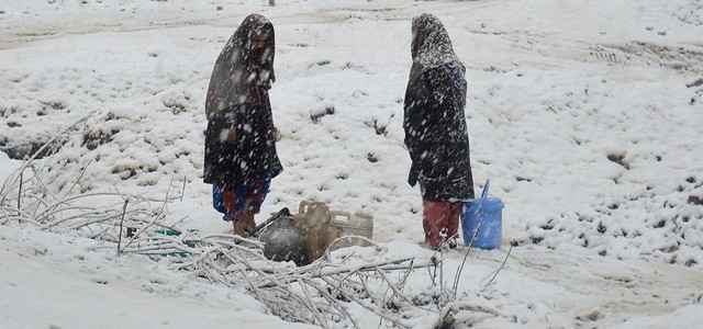 Two young girls, covered with white flakes, brave thick snow for their family’s requirement of water. Even when it is snows everywhere, there are small windows in time when municipal taps yield water drop by drop.