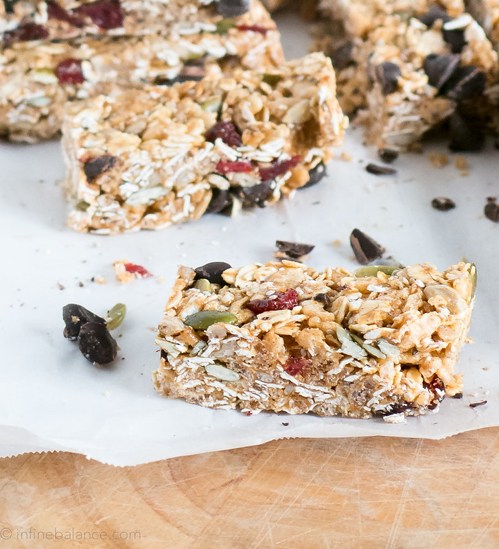 chocolate and cranberry granola bars on parchment paper