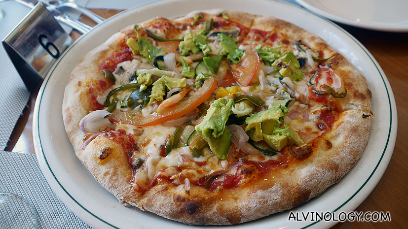 Healthy pizza with avocado, tomato and mushroom toppings 